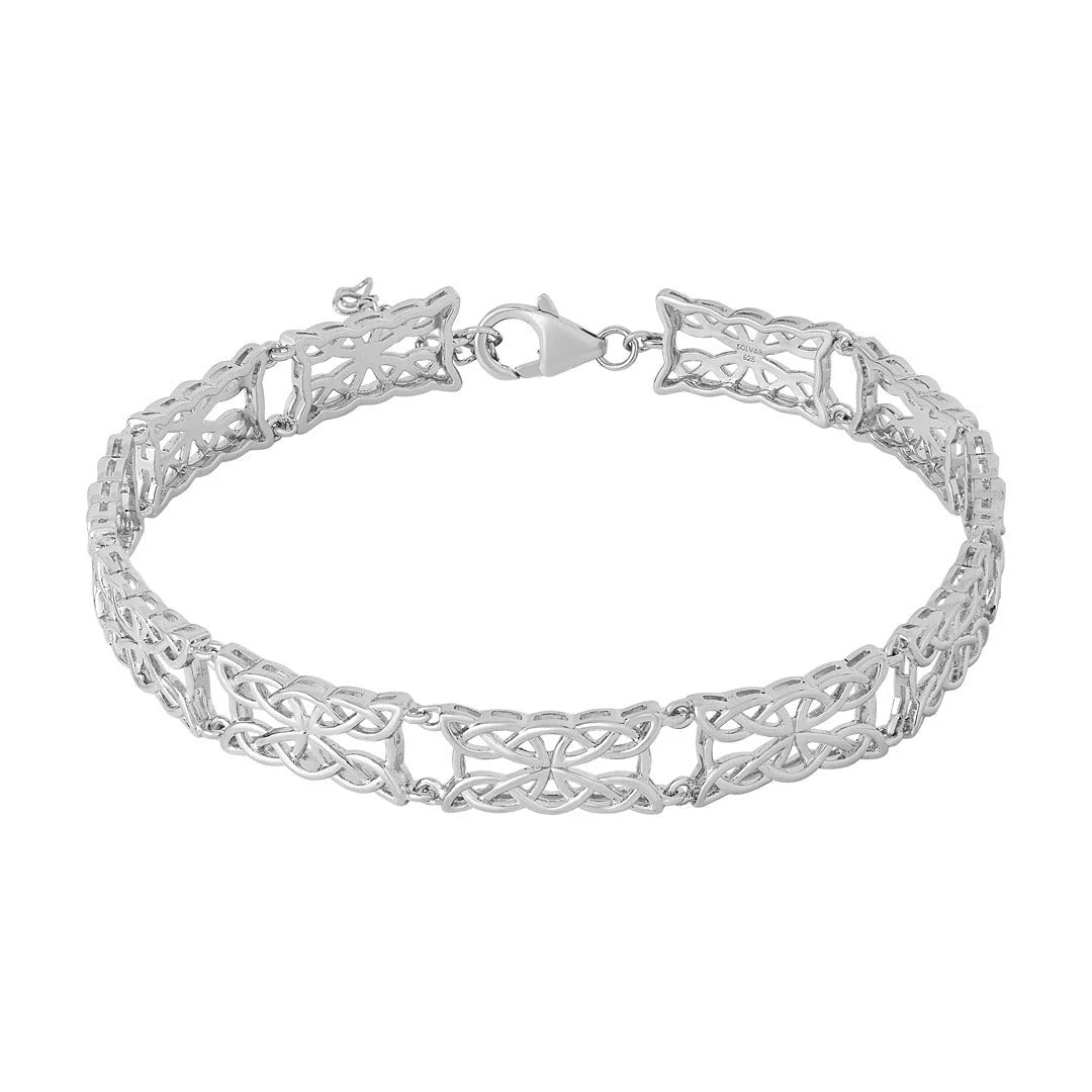 Silver bracelet with intricate design on a white background